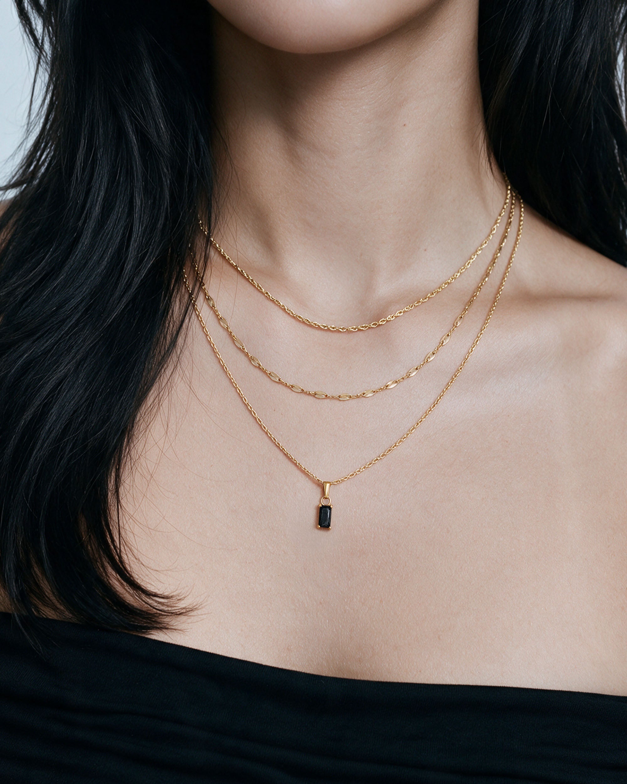 Emerald Cut Necklace Set — Black in gold, worn by a model