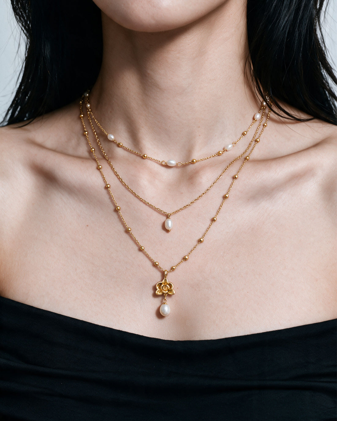 Orchid Pearl Trio Necklace Set in gold, worn by a model