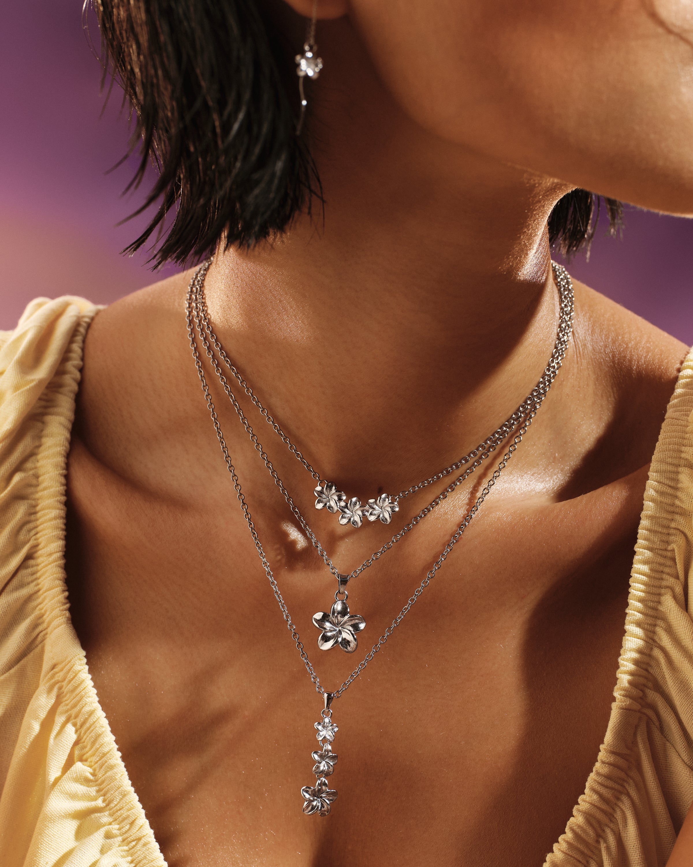 Model wearing the Plumeria Bloom Drop Necklace