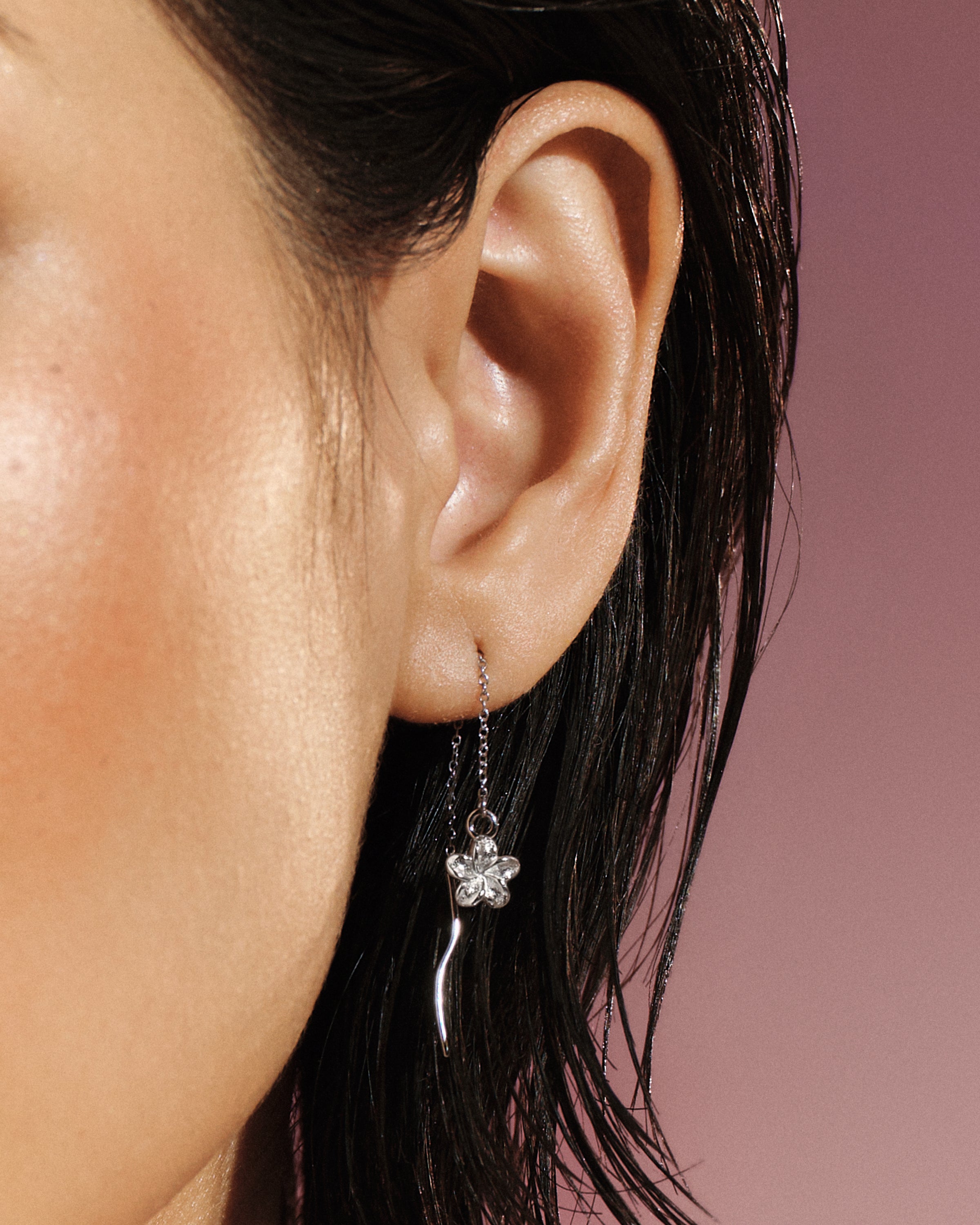 Model wearing the Plumeria Bloom Threader Earring