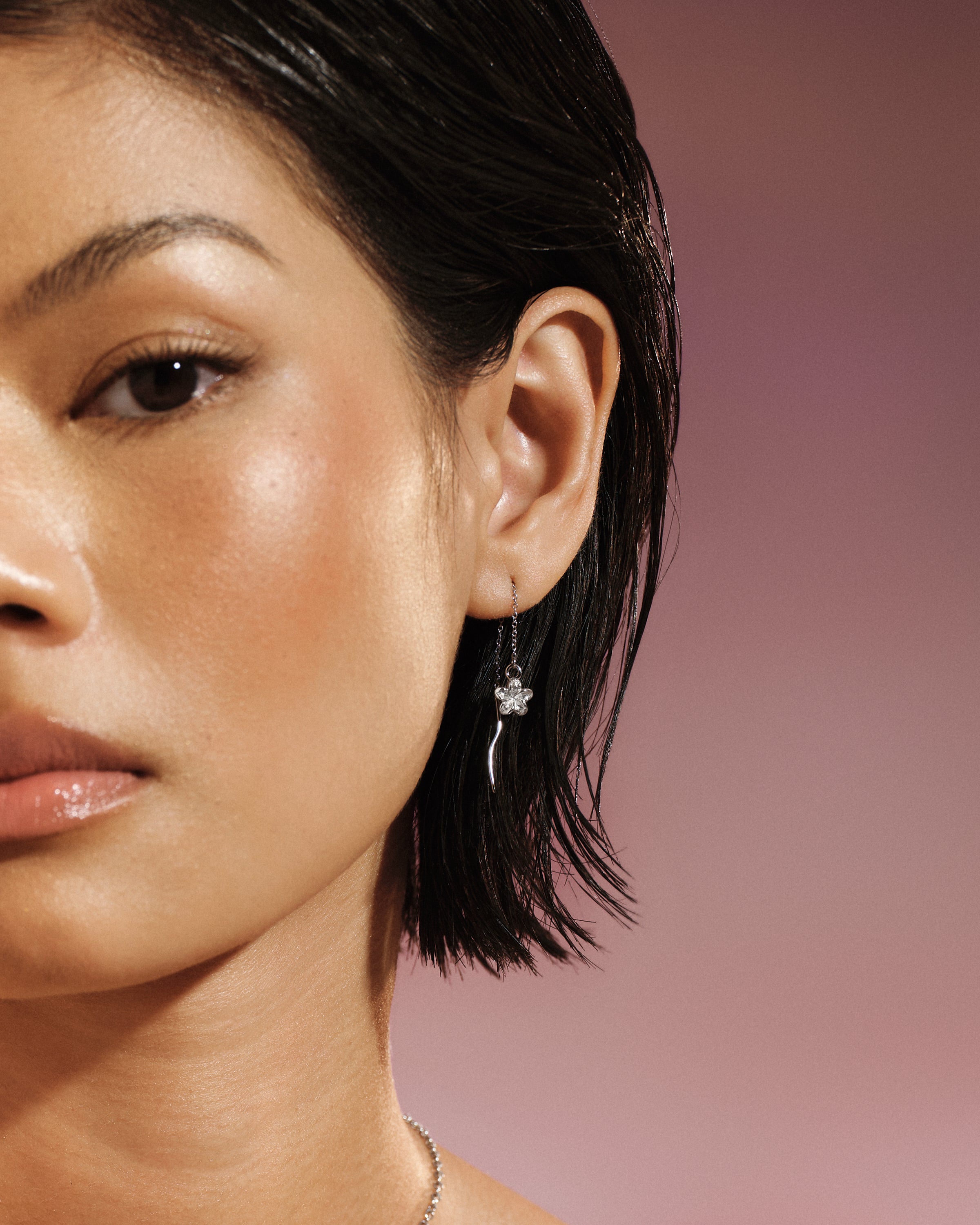 Model wearing the Plumeria Bloom Threader Earring