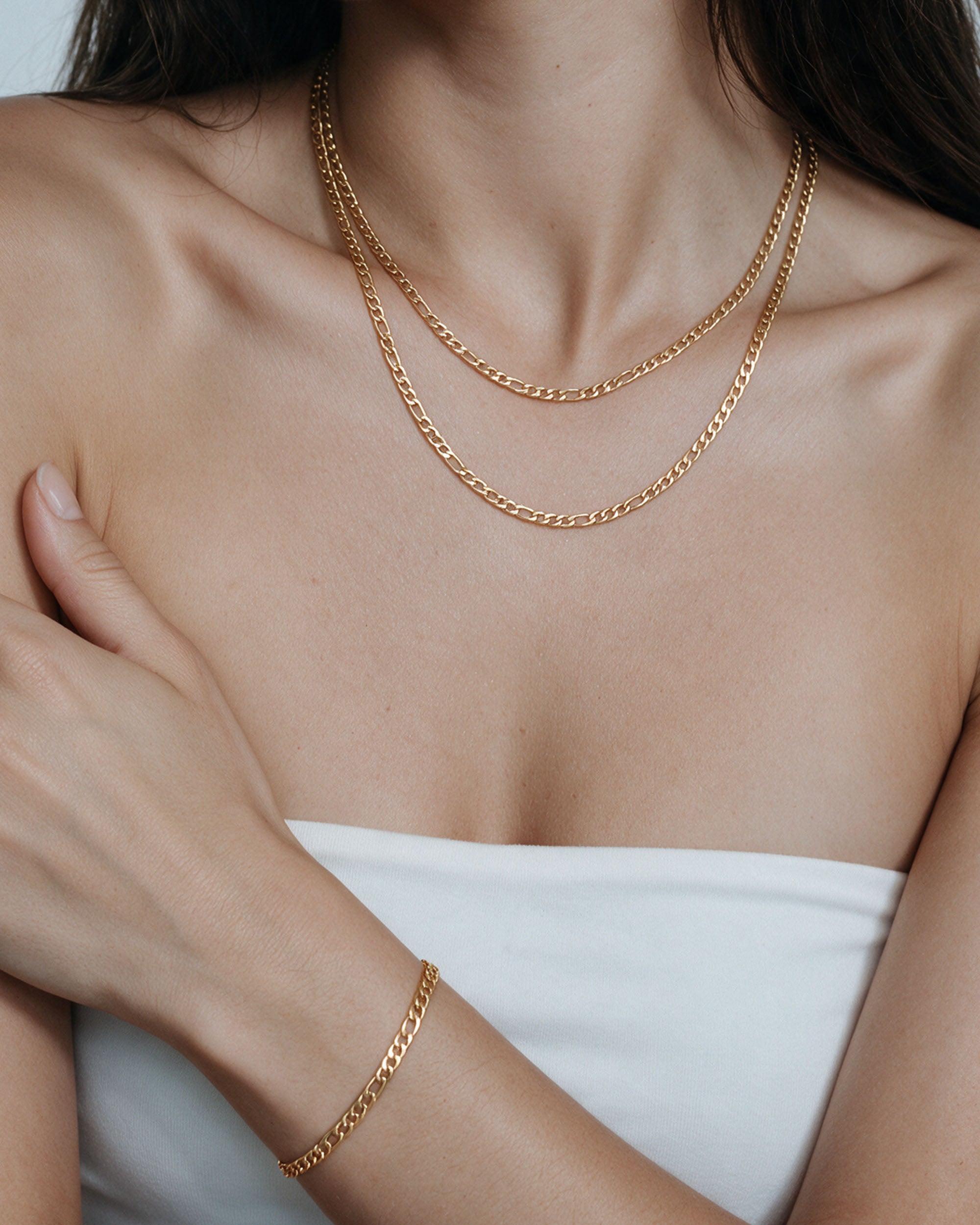 The Figaro Set in gold, worn by a model