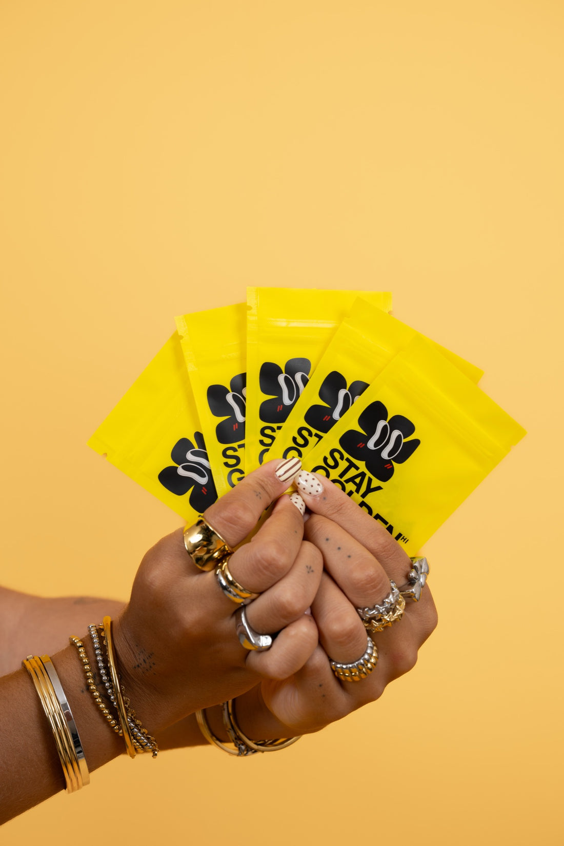 A fan of yellow Stay Golden jewelry pouches
