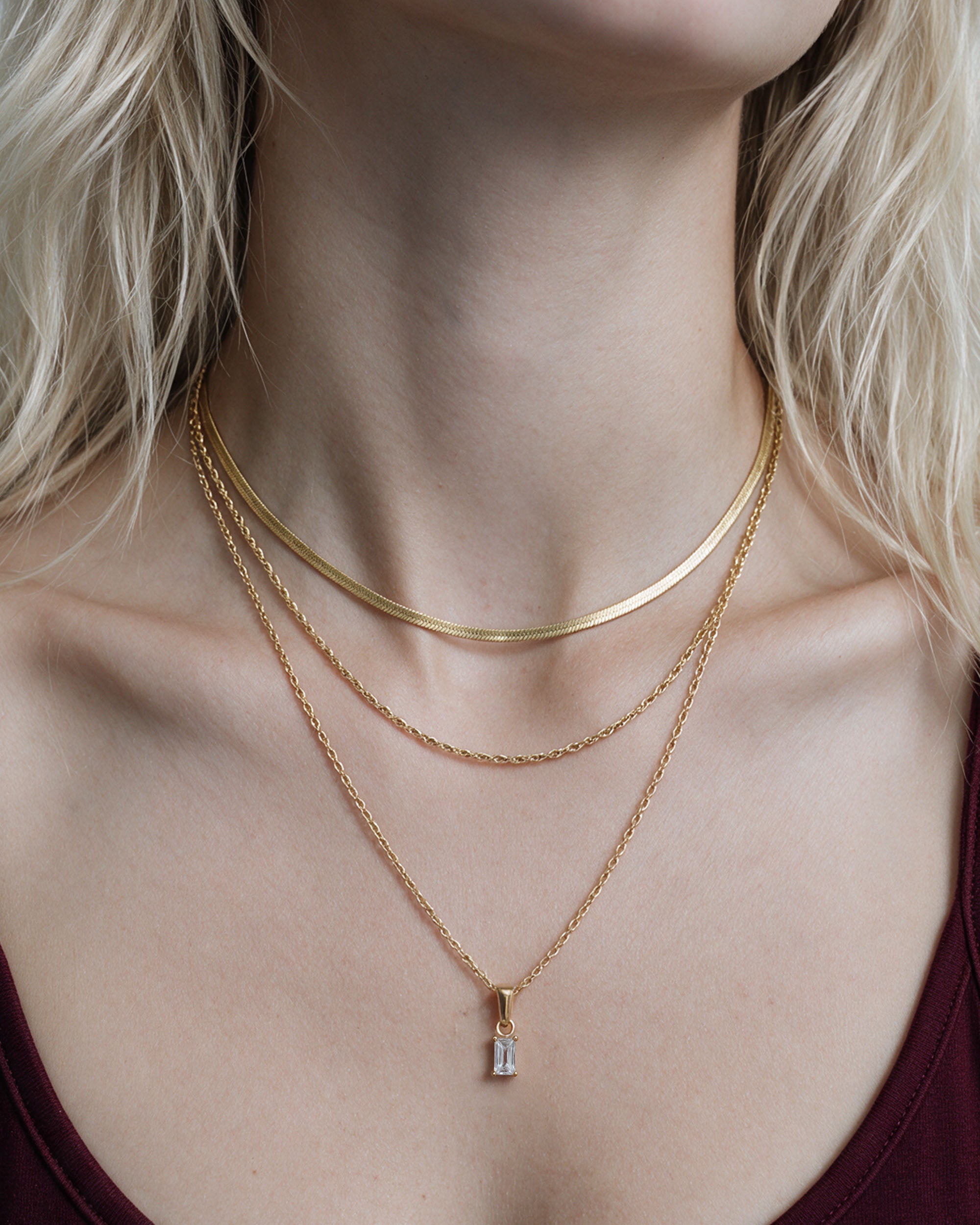 
Herringbone Emerald Set in gold, worn by a model