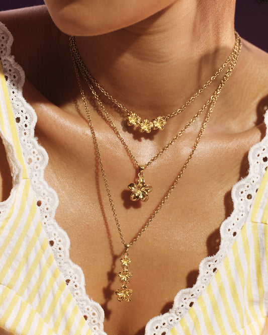 
Model wearing the Plumeria Bloom Drop Necklace