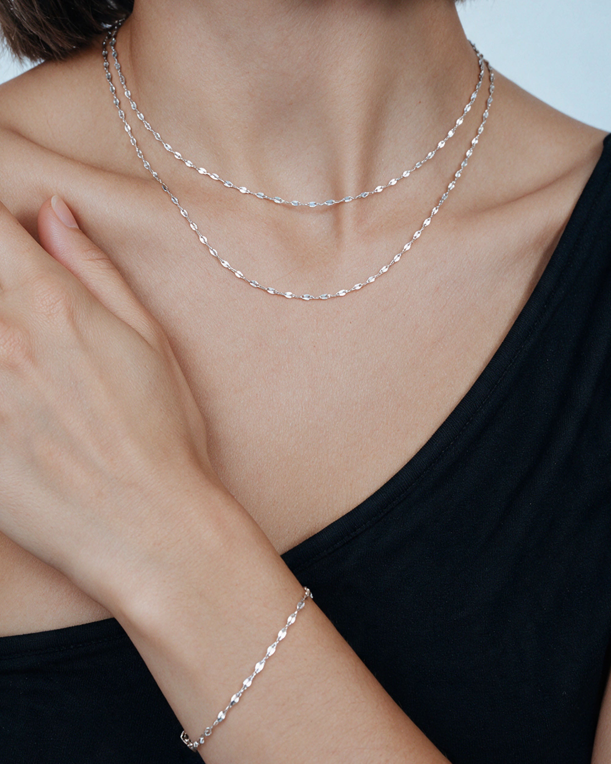 
The Kara Set in silver, worn by a model